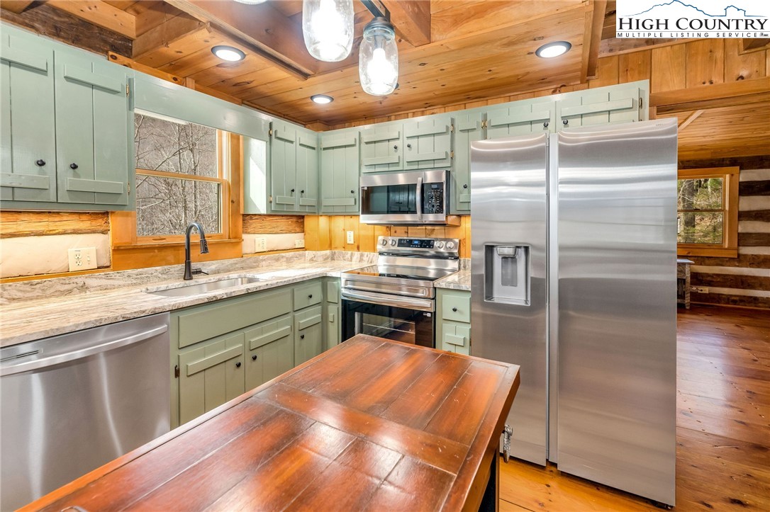 372 Homestead Road Todd, NC 28684 - Photo 21 of 41 a kitchen with stainless steel appliances granite countertop a refrigerator a sink and a stove