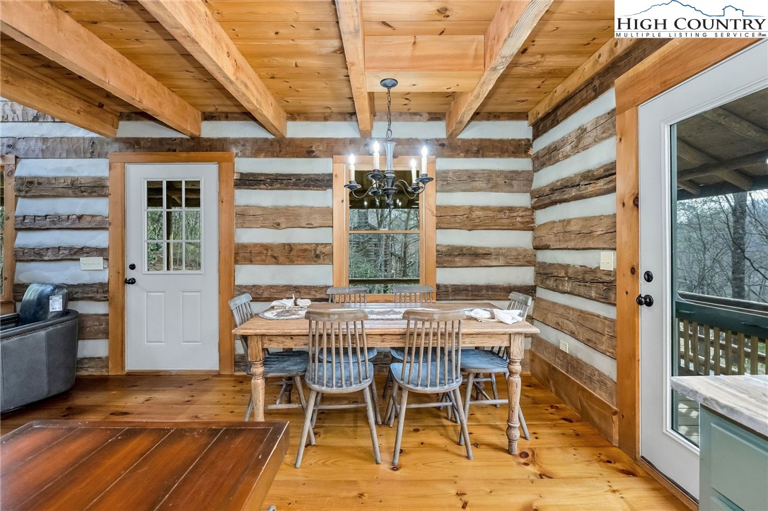 372 Homestead Road Todd, NC 28684 - Photo 23 of 41 a dining room with furniture a chandelier and wooden floor