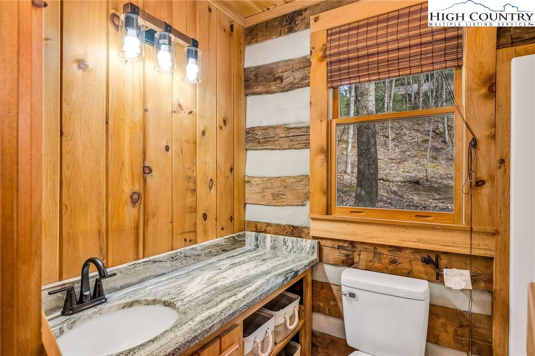 372 Homestead Road Todd, NC 28684 - Photo 29 of 41 a bathroom with a granite countertop sink and a mirror