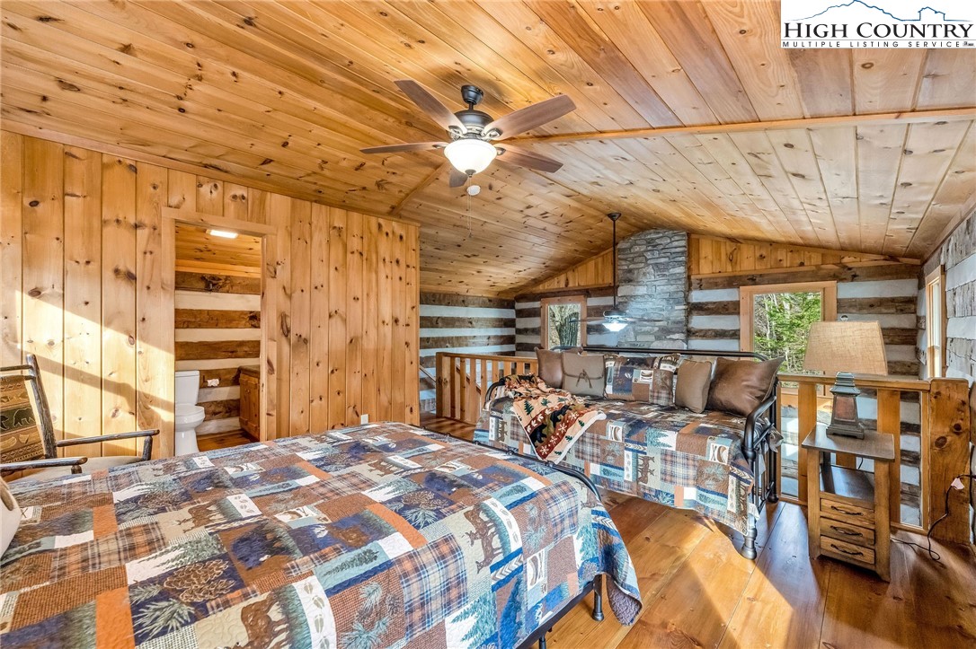 372 Homestead Road Todd, NC 28684 - Photo 33 of 41 a bedroom with a bed a table and chair