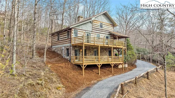 a living room with furniture a fireplace and a table