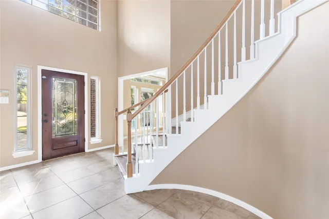 a view of staircase with lots of frames and couches