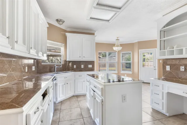 a kitchen with cabinets appliances a sink and a counter top space