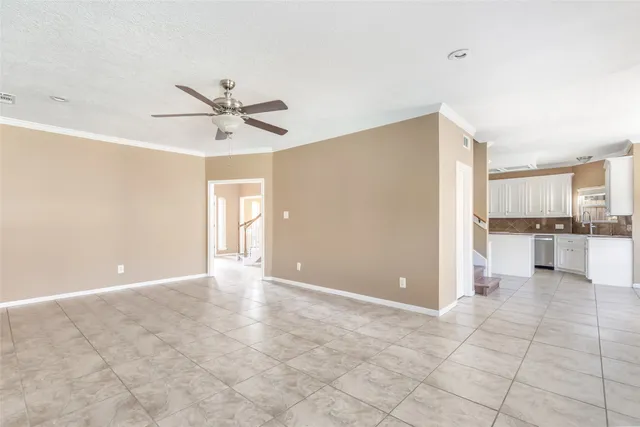 a view of a kitchen with a sink and a kitchen island