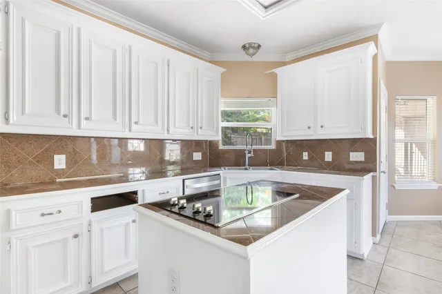 a kitchen with stainless steel appliances granite countertop a sink stove and cabinets