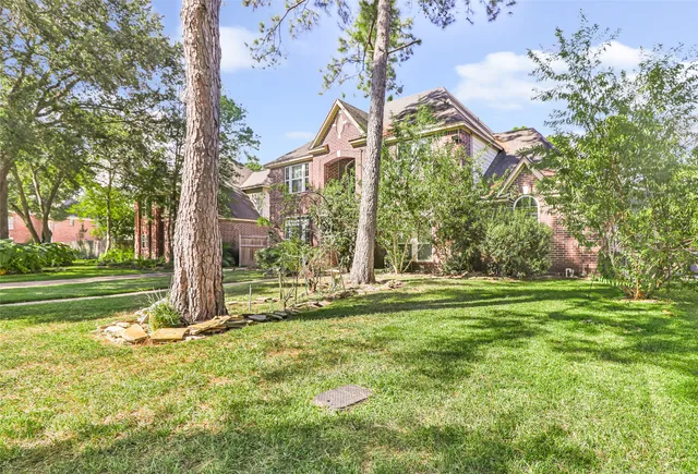 a view of a house with a big yard and potted plants