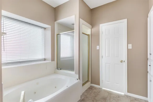 a spacious bathroom with a double vanity sink a mirror and a bathtub