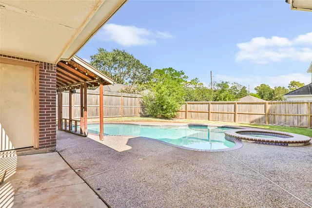 a view of backyard with swimming pool and outdoor seating