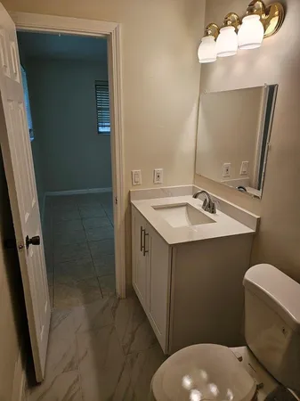 a bathroom with a sink a toilet and mirror