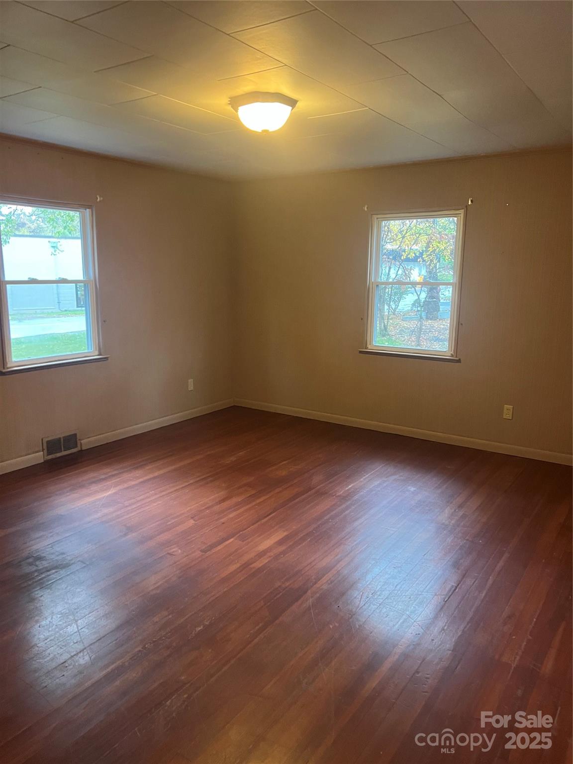 243 Governors View Road Asheville, NC 28805 - Photo 16 of 17 an empty room with wooden floor and windows