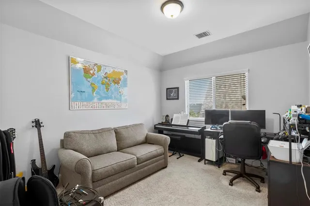 a room with pool table and windows