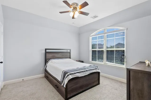 a room with pool table and windows