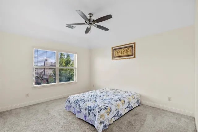 a spacious bedroom with a bed and a window