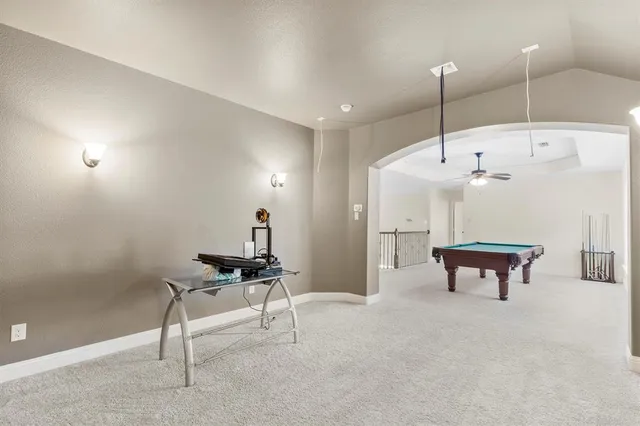 a bathroom with a tub shower and sink