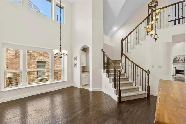 a living room with fireplace furniture and a kitchen view