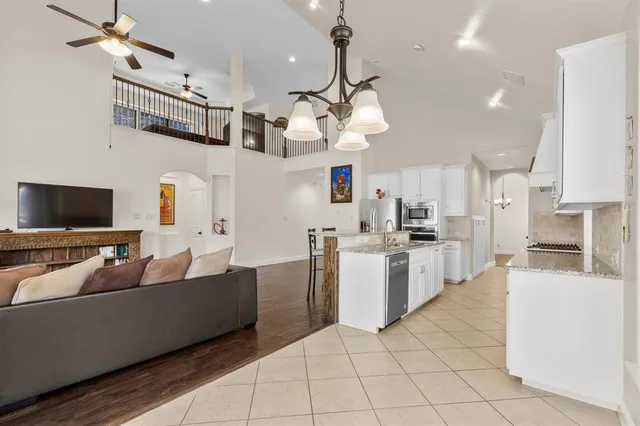 a living room with furniture fireplace and wooden floor