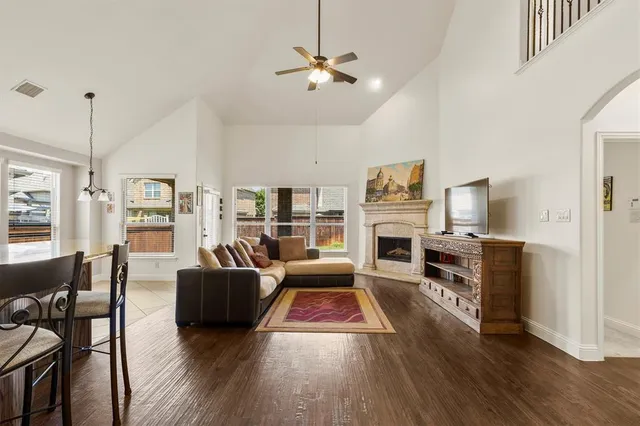 a living room with fireplace furniture and a wooden floor