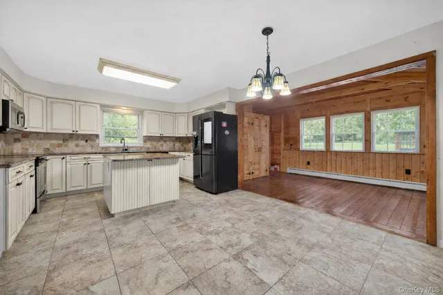a bathroom with a granite countertop sink a toilet and a mirror