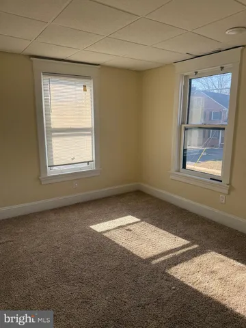 an empty room with a empty space and windows