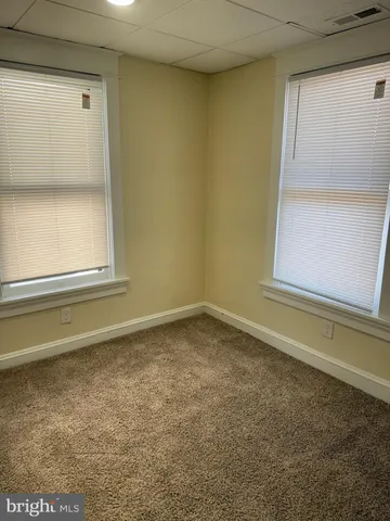 a view of an empty room and a window