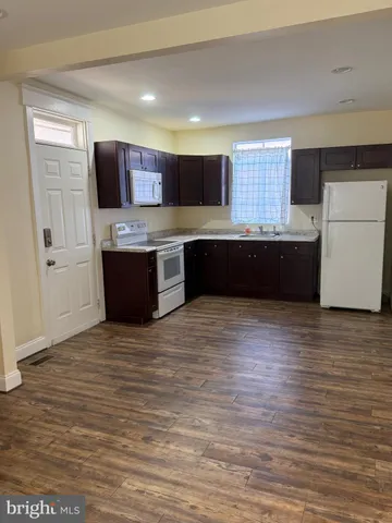 a kitchen with stainless steel appliances wooden cabinets and a counter top space