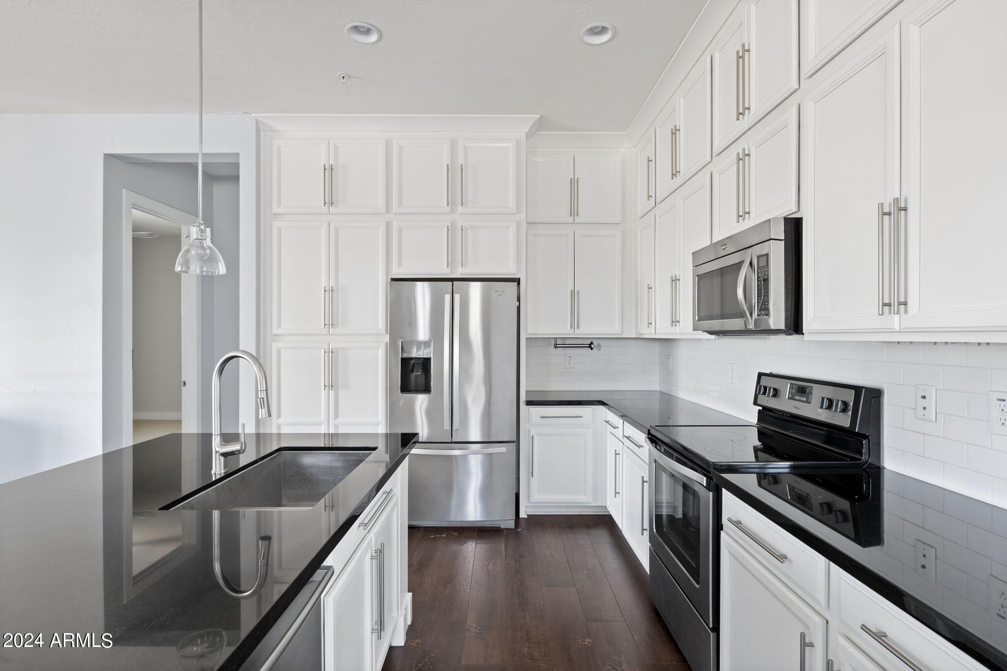 6565 East Thomas Road, Unit 1109 Scottsdale, AZ 85251 - Photo 13 of 40 a kitchen with granite countertop a sink a counter space stainless steel appliances and cabinets