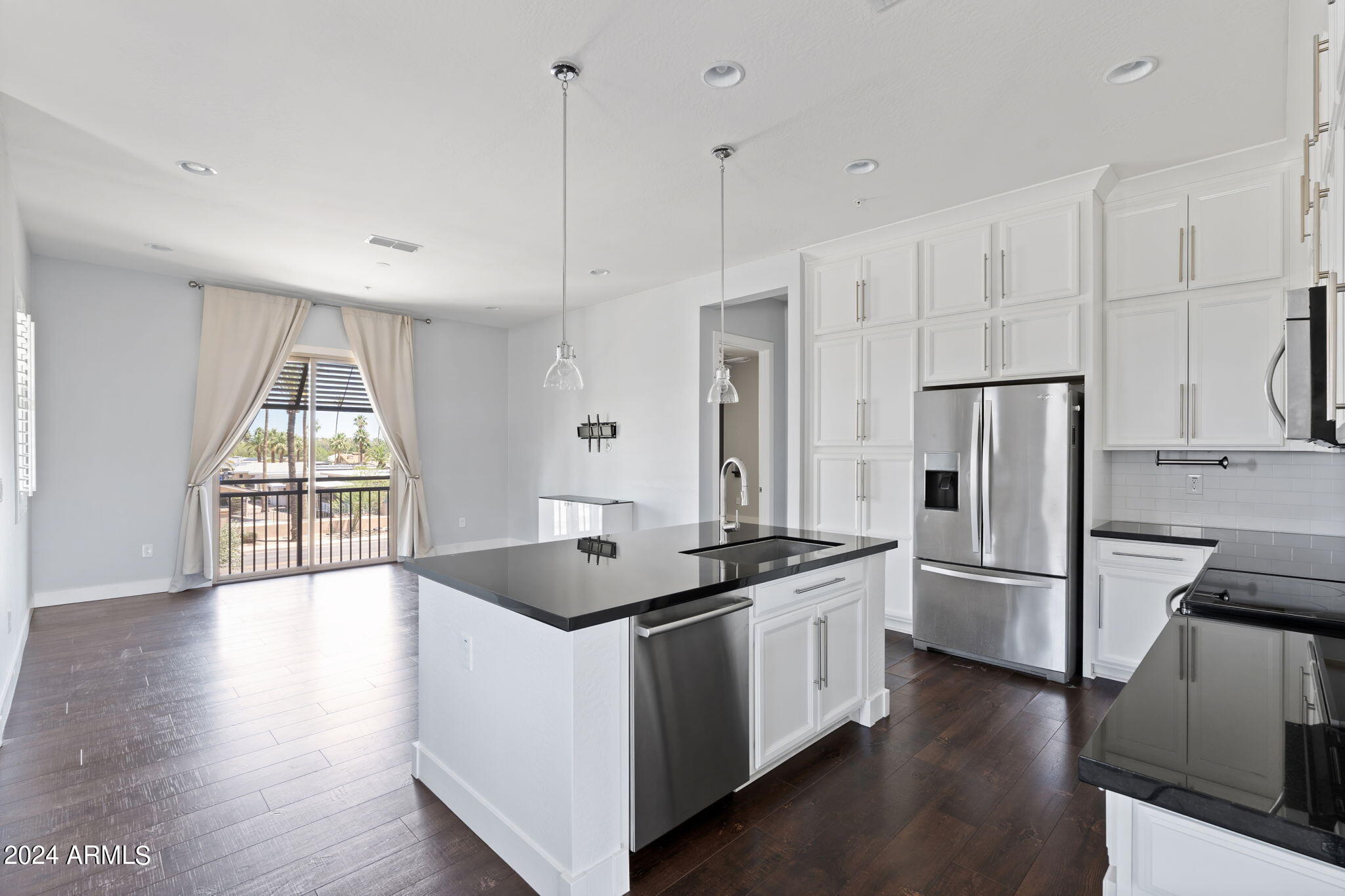 6565 East Thomas Road, Unit 1109 Scottsdale, AZ 85251 - Photo 14 of 40 a kitchen with stainless steel appliances granite countertop a refrigerator a sink and a stove