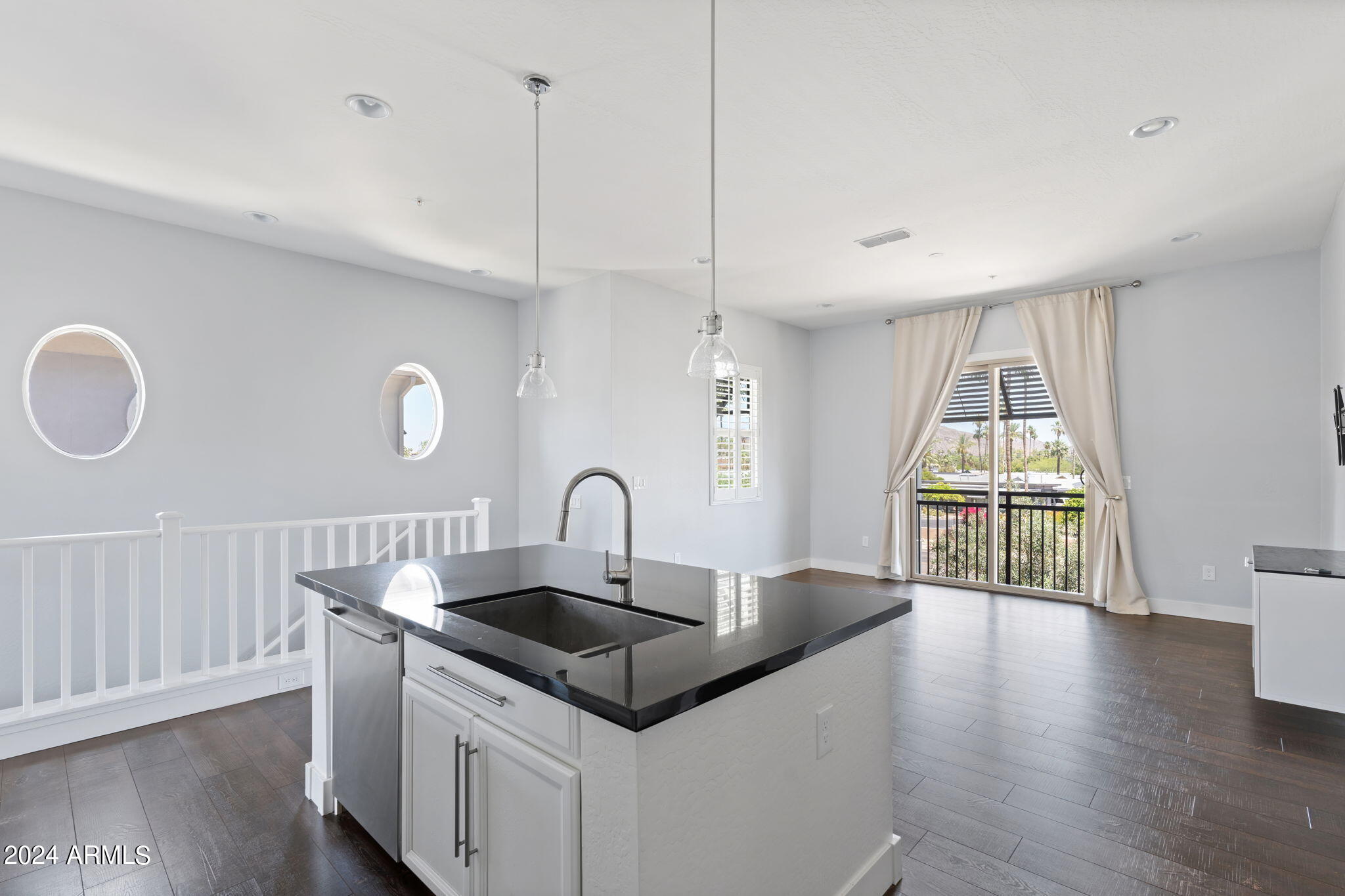 6565 East Thomas Road, Unit 1109 Scottsdale, AZ 85251 - Photo 15 of 40 a kitchen with a sink a dining table and chairs