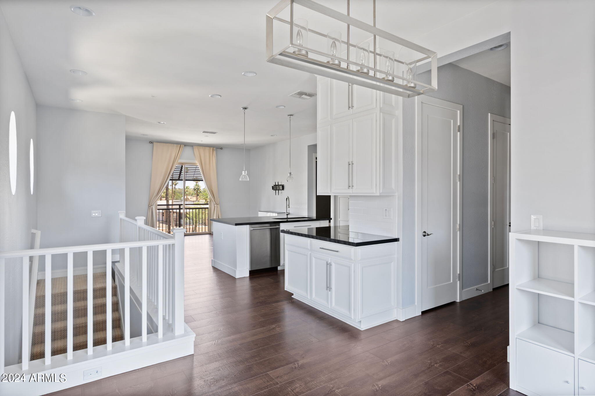 6565 East Thomas Road, Unit 1109 Scottsdale, AZ 85251 - Photo 40 of 40 a kitchen with stainless steel appliances a white cabinets and wooden floor