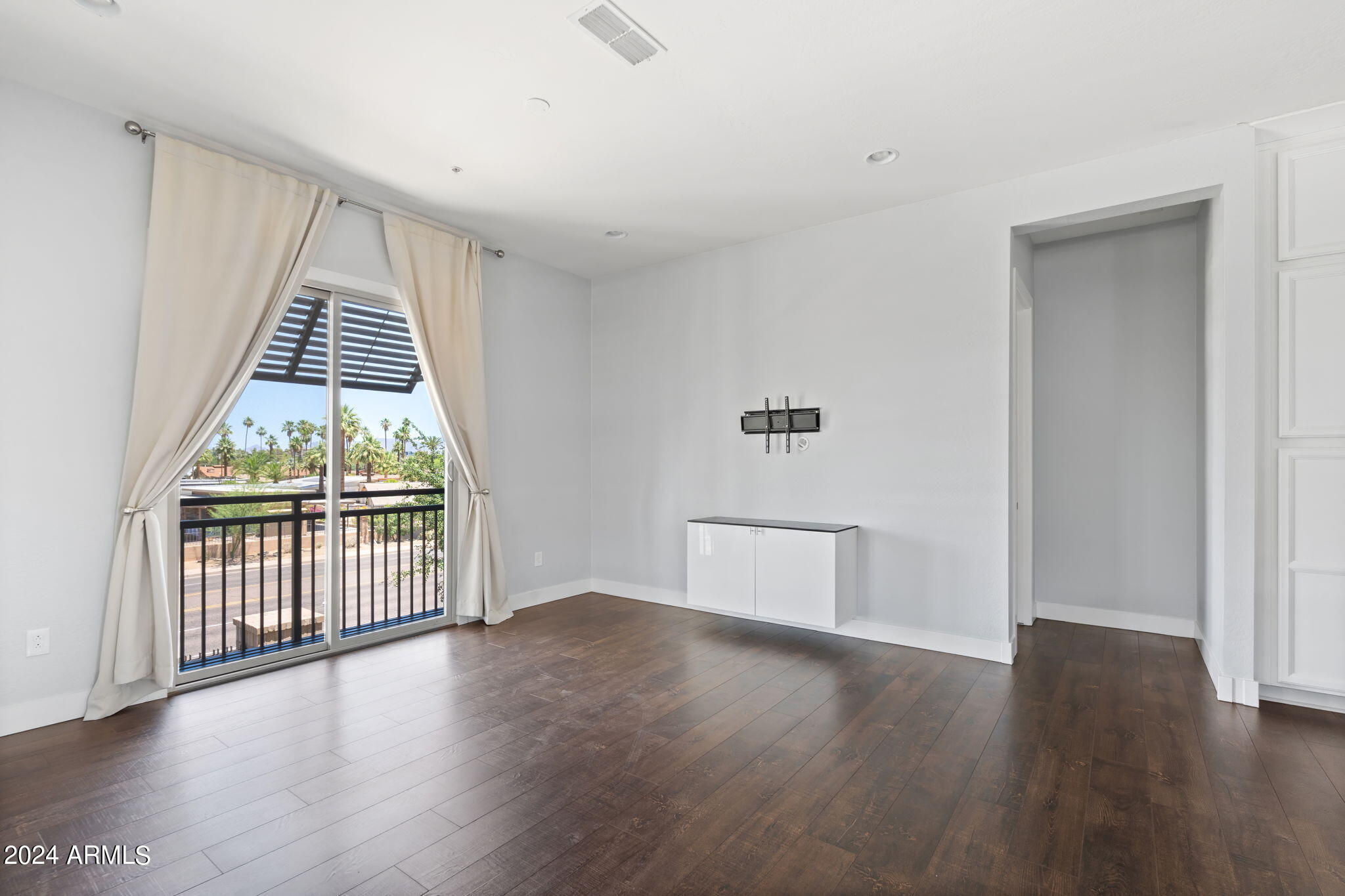 6565 East Thomas Road, Unit 1109 Scottsdale, AZ 85251 - Photo 22 of 40 an empty room with wooden floor and windows
