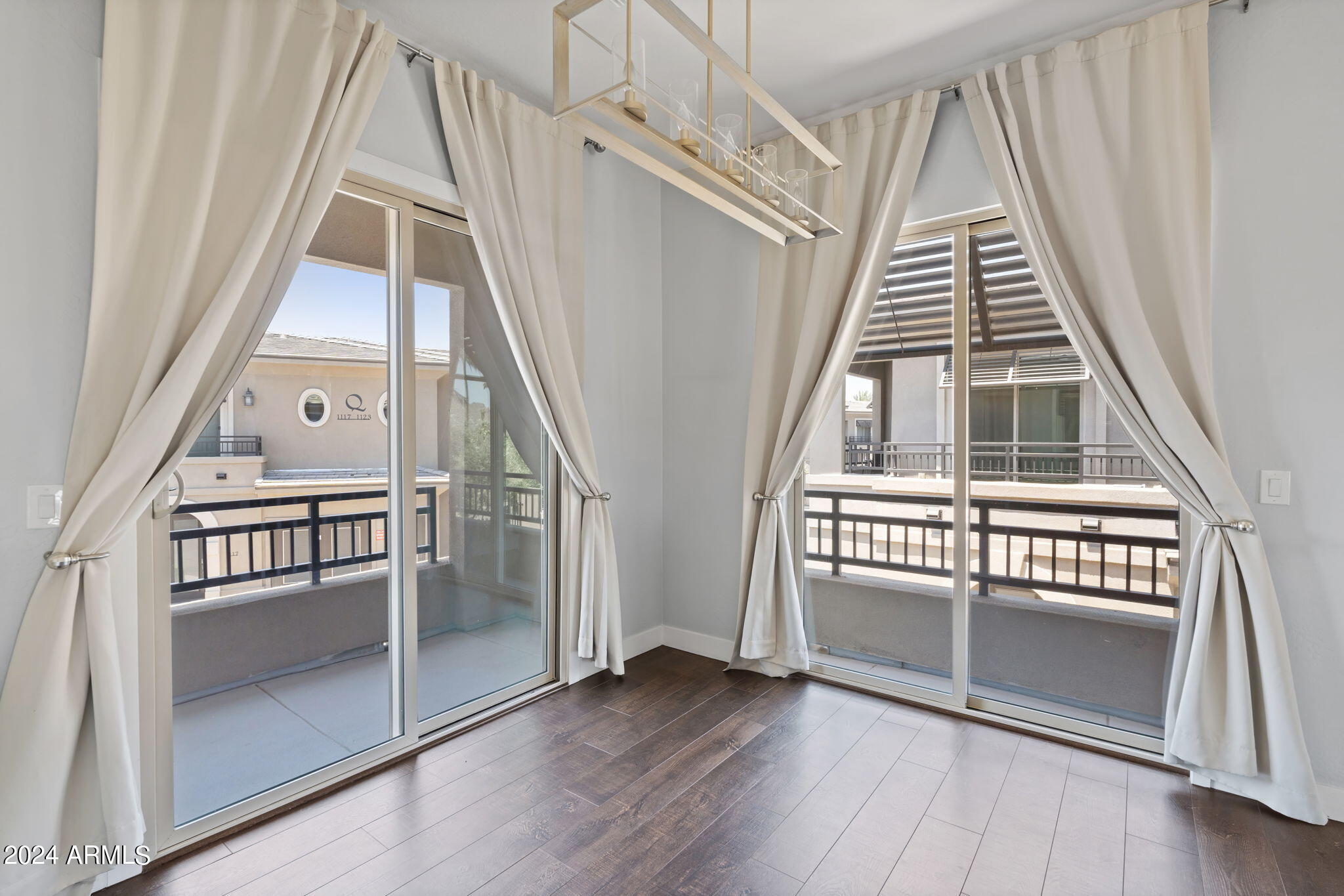 6565 East Thomas Road, Unit 1109 Scottsdale, AZ 85251 - Photo 3 of 40 an empty room with wooden floor fan and windows