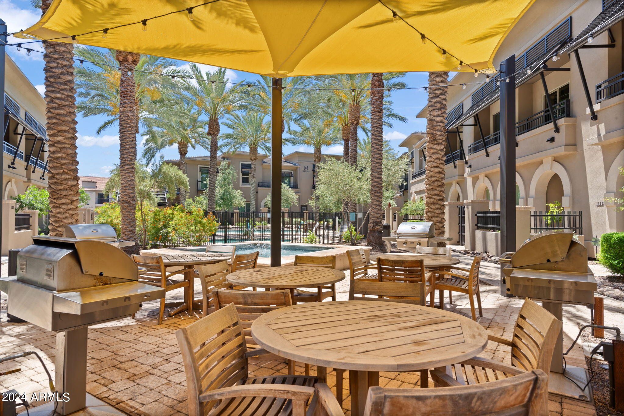 6565 East Thomas Road, Unit 1109 Scottsdale, AZ 85251 - Photo 36 of 40 a view of a patio with couches table and chairs under an umbrella