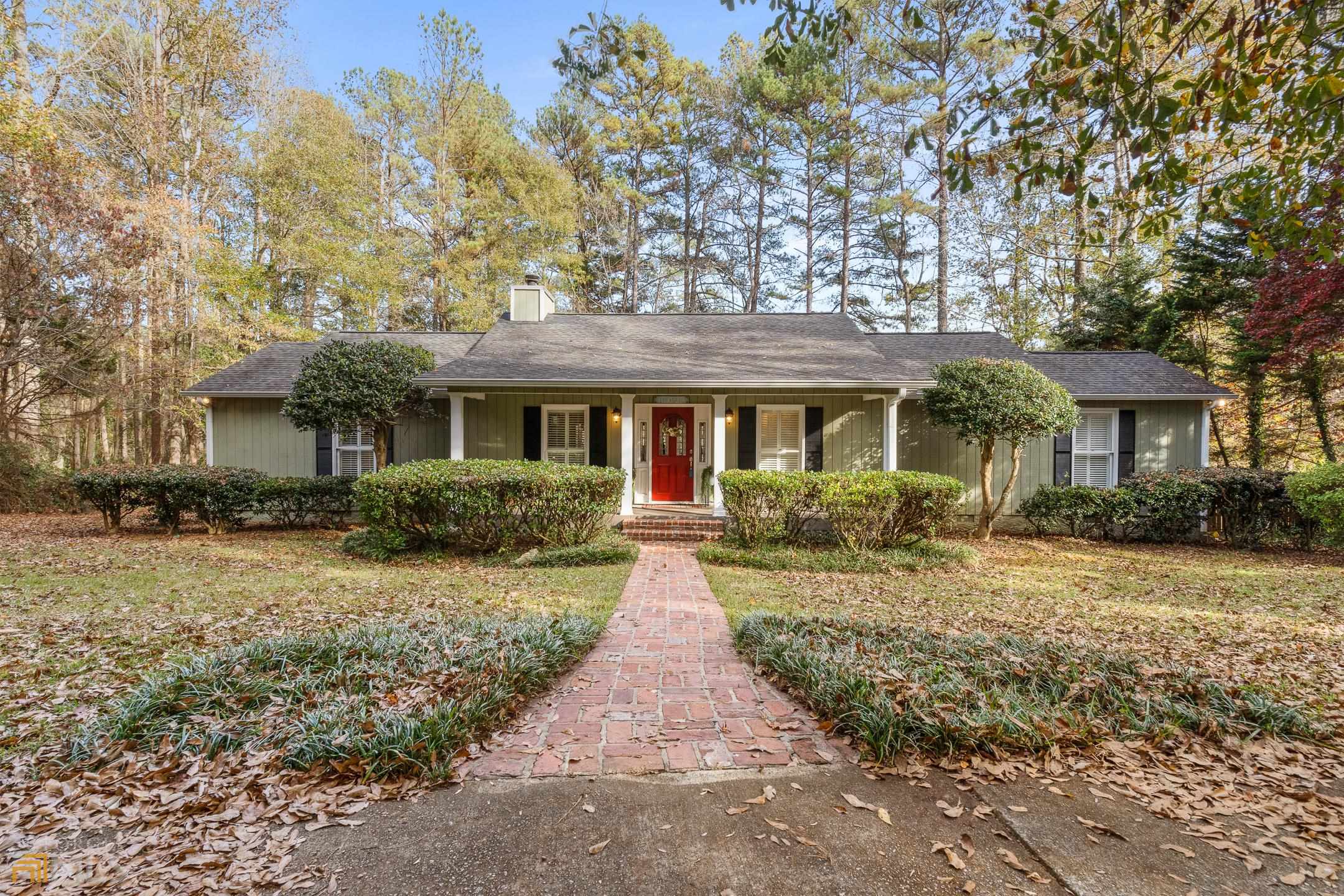1115 Roscoe Road Newnan, GA 30263 - Photo 1 of 1 a front view of a house with yard patio and green space