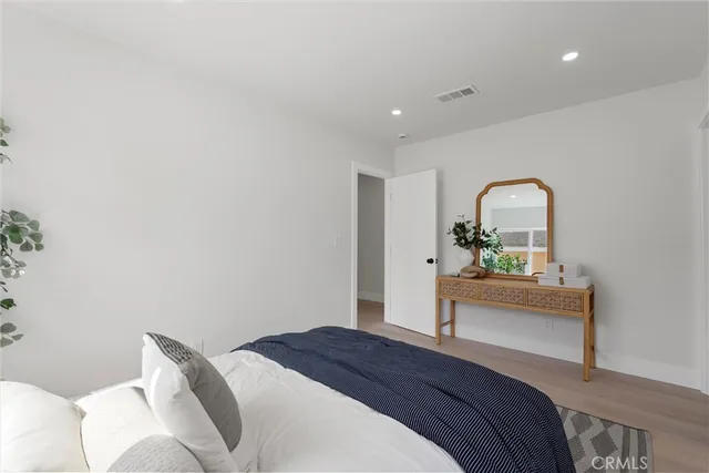 a bedroom with a bed and a dresser