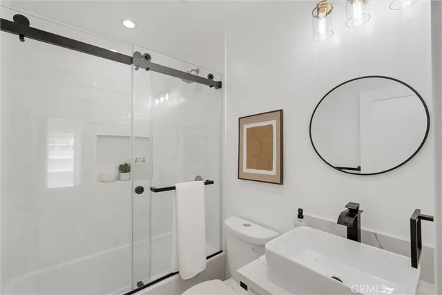 a bathroom with a toilet sink and shower