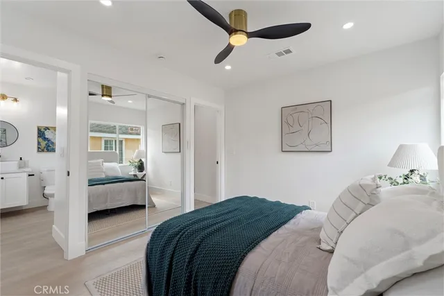 a bedroom with a bed and painting on the wall