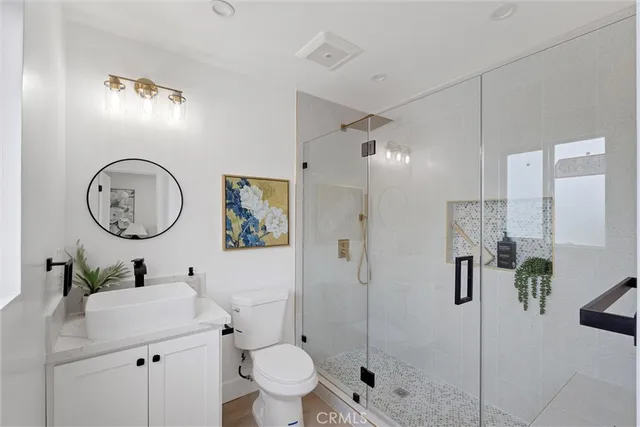 a bathroom with a toilet sink and shower