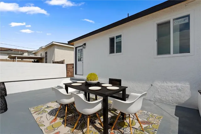 a roof deck with table and chairs