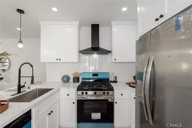 a kitchen with stainless steel appliances granite countertop a sink stove and refrigerator