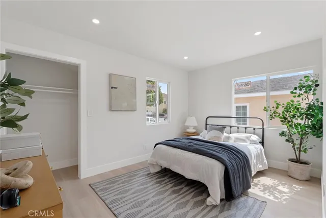 a bedroom with a bed and a potted plant