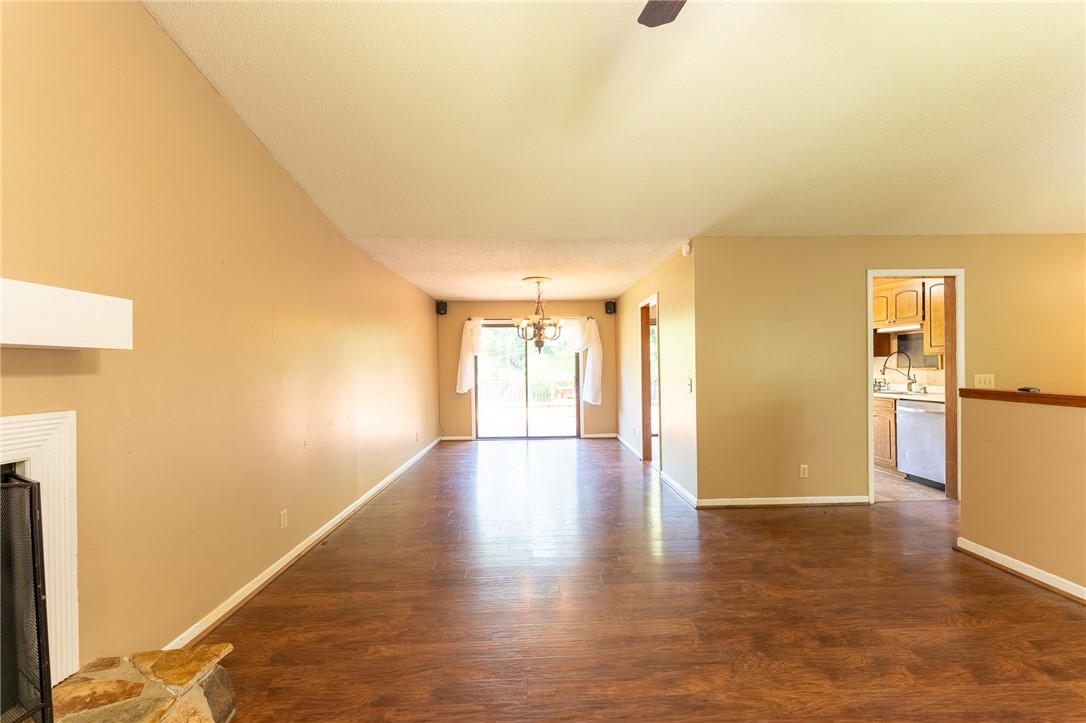 117 Shaftsbury Road Clemson, SC 29631 - Photo 3 of 29 Rich wood flooring connects the open-concept living area to an adjoining kitchen space.