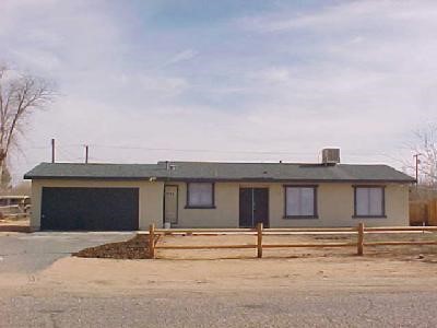 14833 Quinnault Road Apple Valley, CA 92307 - Photo 1 of 1 a front view of a house with a garage
