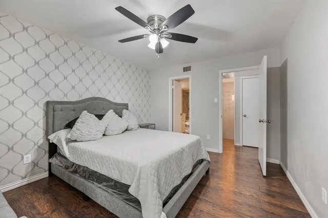 a bedroom with a bed and a ceiling fan