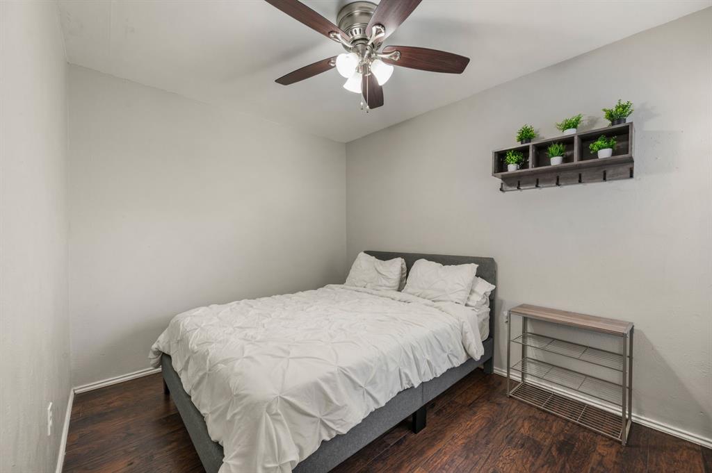 11311 Audelia Road, Unit 265 Dallas, TX 75243 - Photo 14 of 17 a bedroom with bed and a chandelier