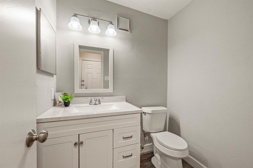 11311 Audelia Road, Unit 265 Dallas, TX 75243 - Photo 15 of 17 a bathroom with a toilet sink and mirror