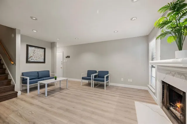 a living room with furniture a fireplace and a potted plant
