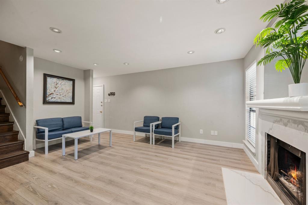 11311 Audelia Road, Unit 265 Dallas, TX 75243 - Photo 6 of 17 a living room with furniture a fireplace and a potted plant