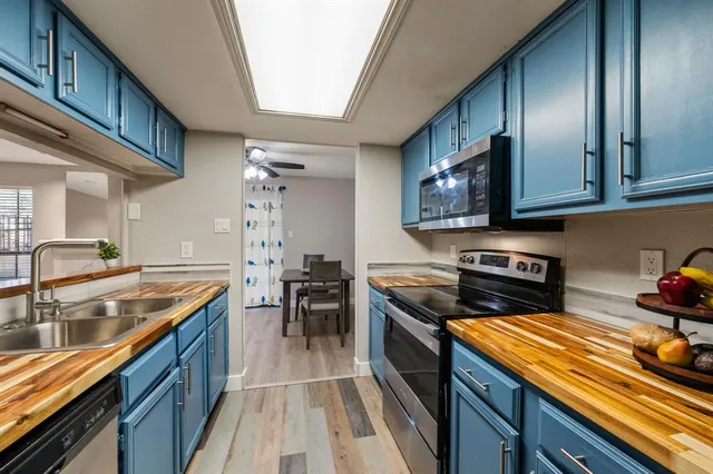 a kitchen with stainless steel appliances granite countertop a sink stove and cabinets