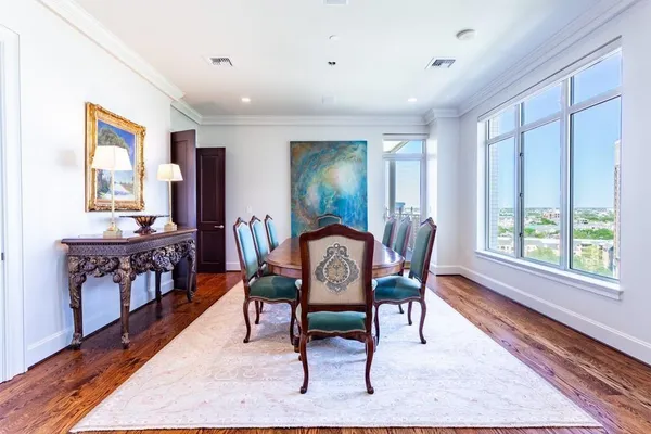 a dining room with furniture a rug and wooden floor