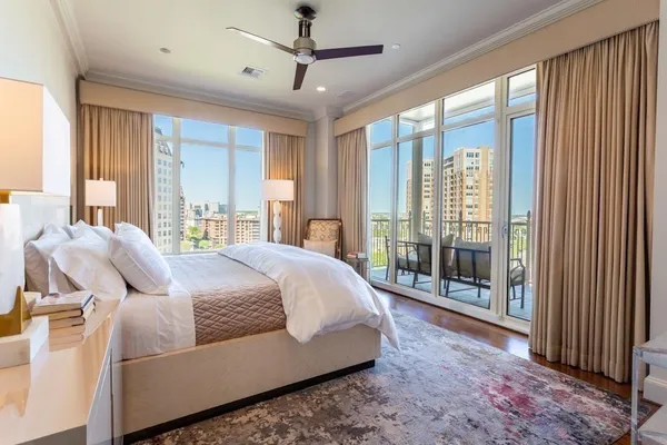 a bedroom with a large bed and a large window